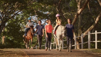 一位母亲与她的孩子在巴西立的 Gallop Stable 骑小马