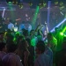 Party goers dancing amidst green lights at Zouk