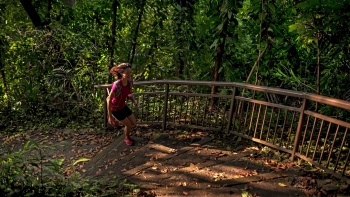 一位女士正沿着花柏山公园玛朗小径 (Marang Trail) 的阶梯小跑