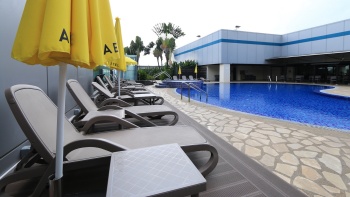 Aerotel 酒店户外泳池旁的一排黄色遮阳伞