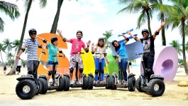 Tour participants on Segway scooters at Siloso Beach, Sentosa 