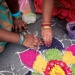 Colourful flower design Rangoli created on the floor